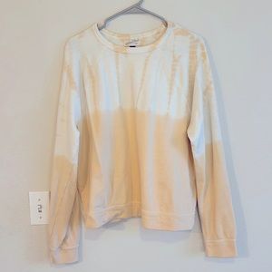size large, fits like a medium, cream/white and light peach colors.